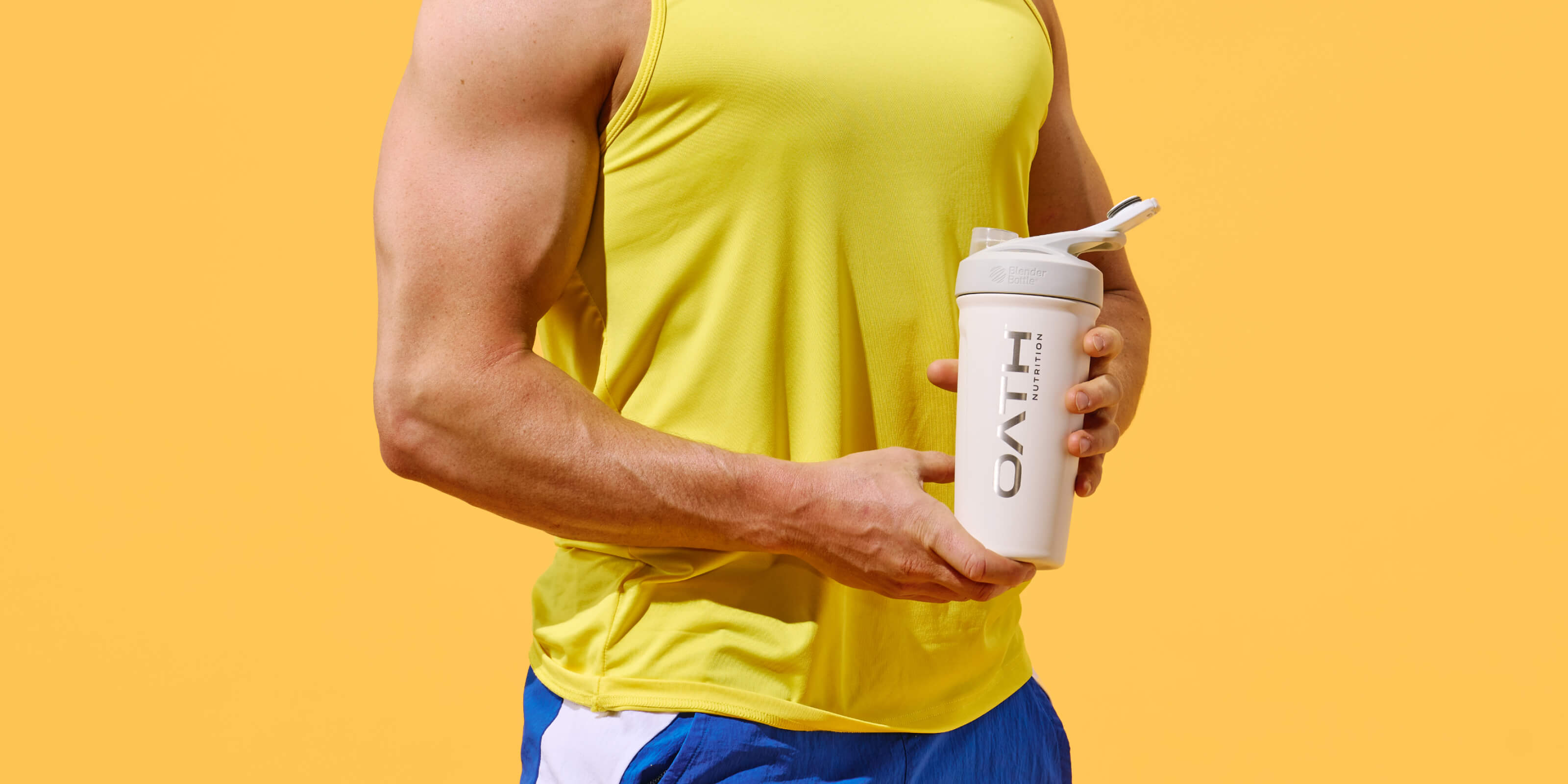Man holding Oath Nutrition shaker cup with clear protein in it
