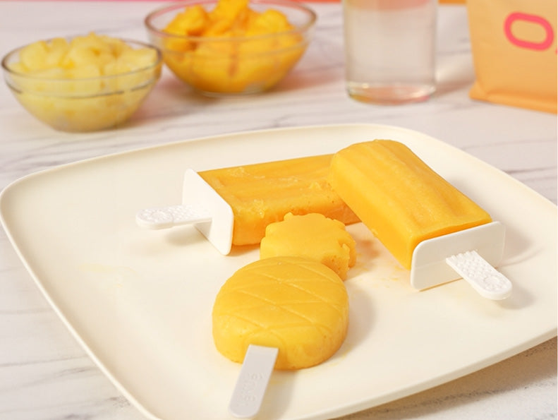 Clear Protein Popsicles on a plate next to a bag of Oath Clear Whey Protein Powder