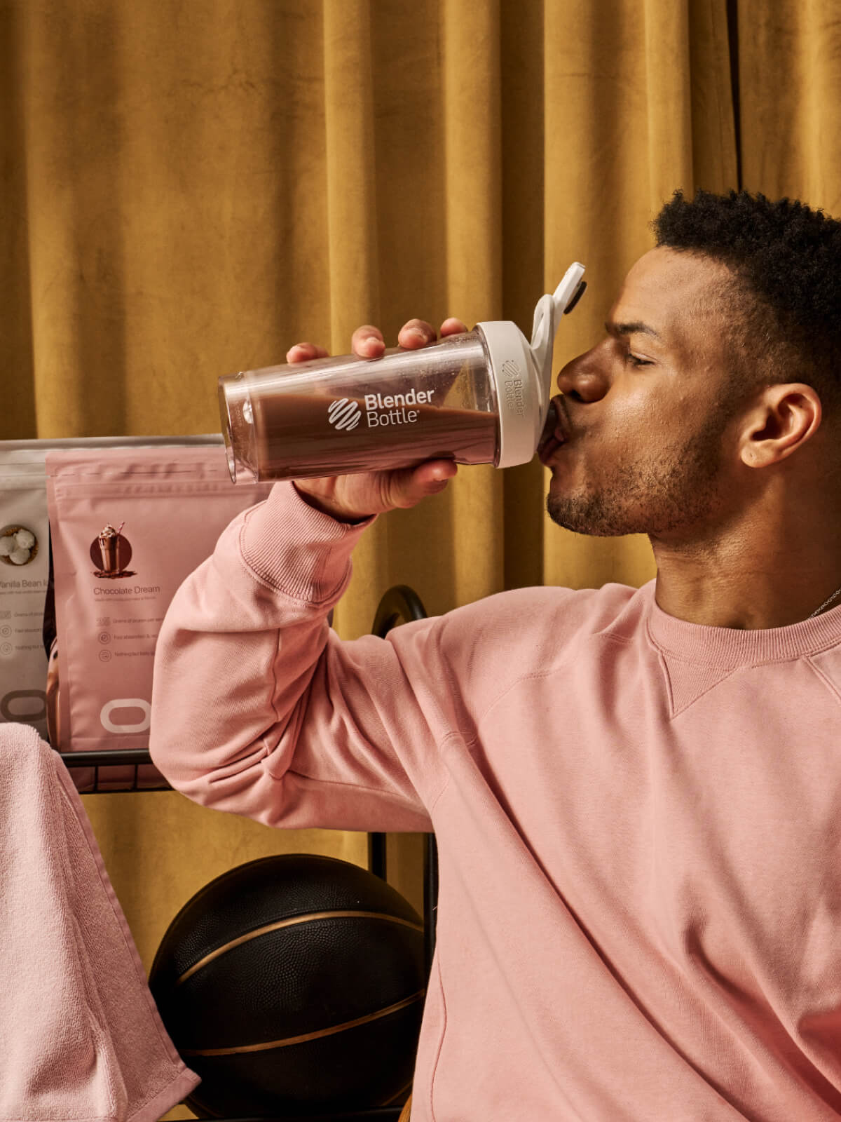 Man drinking delicious Oath chocolate whey protein isolate and concentrate form a BlenderBottle protein shaker