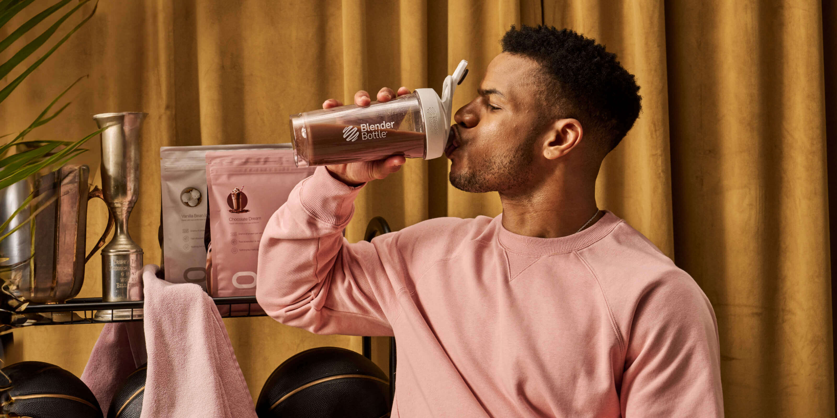 Man drinking delicious Oath chocolate whey protein isolate and concentrate form a BlenderBottle protein shaker